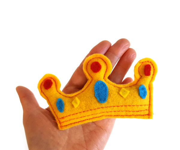 crown cat toy in a human palm to show the size