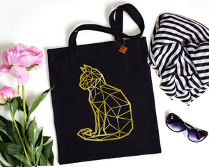 gold foil cat print on a black tote bag